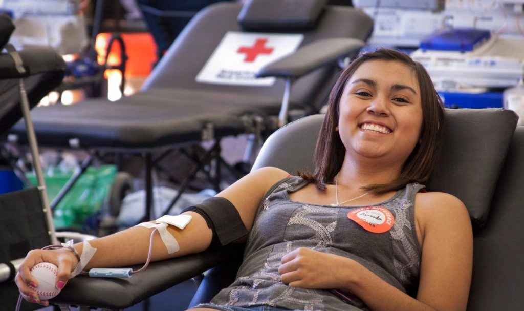 Smiling blood donor during the donation process.  